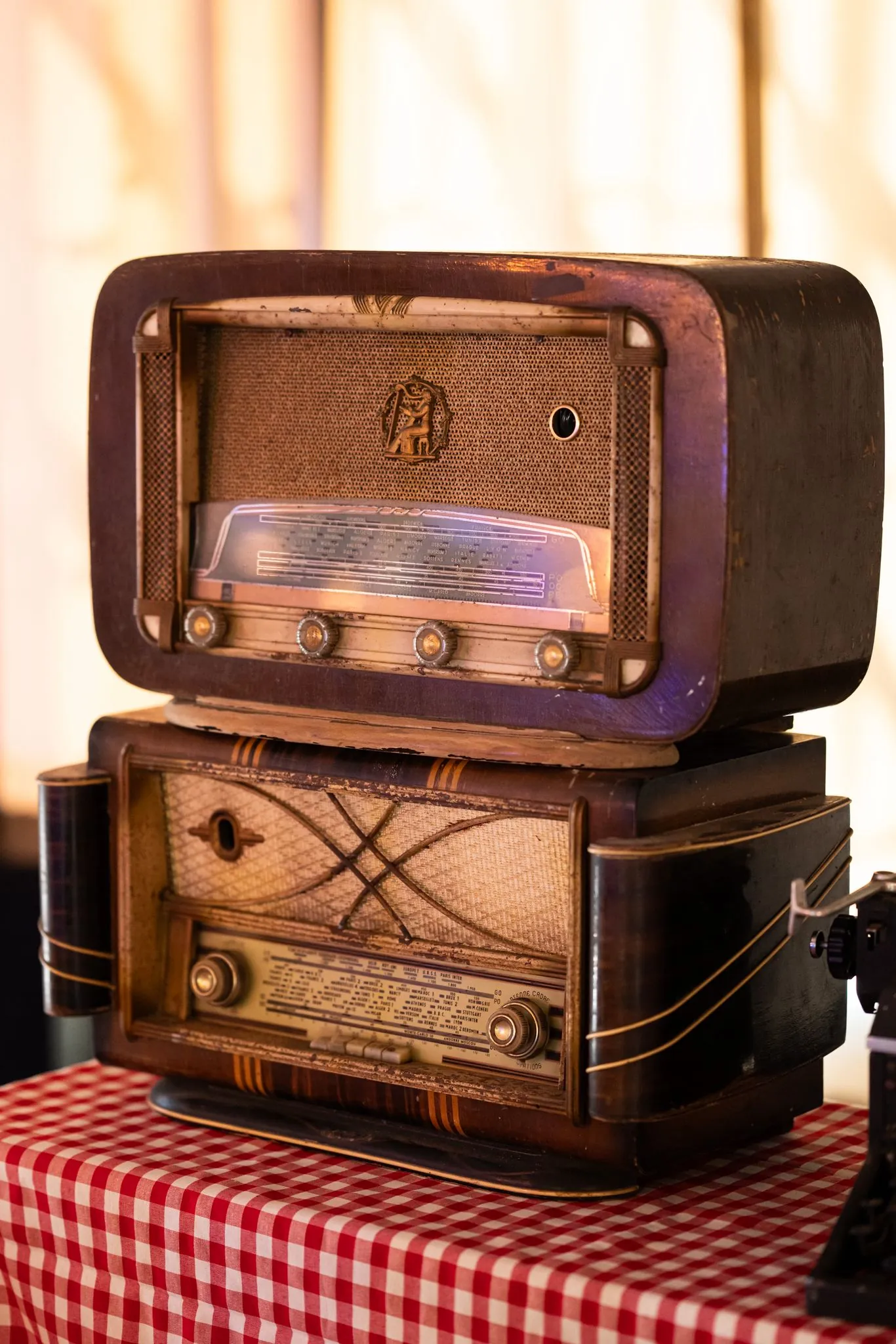 Postes de radio anciens empilés sur une nappe à carreaux